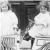 Blanche and Flora with their cut-out car made of cardboard c.1909